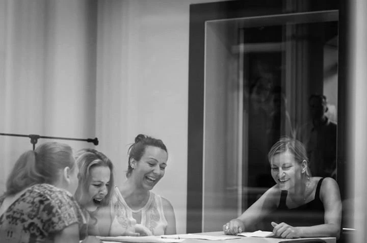 Women laughing at rehearsal table