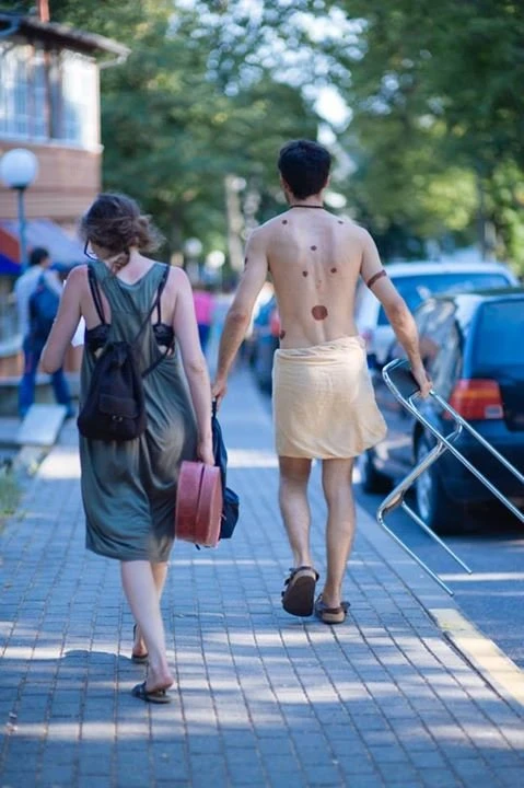 Performer walking with body paint